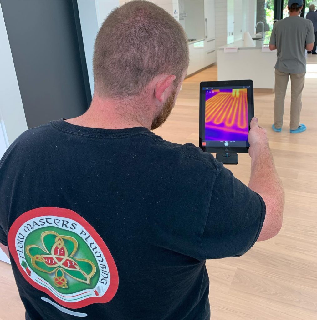 Plumber in San Francisco calibrating a radiant floor heating system