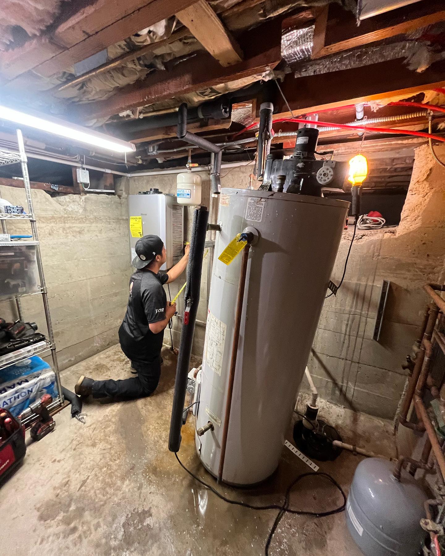 Emergency plumber from Flow Masters inspecting a leaking water heater in 1-day turnaround.