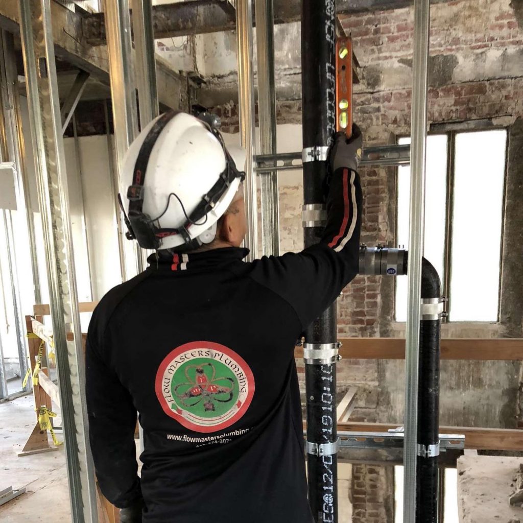 A technician getting measurements for a plumbing project in Palo Alto.