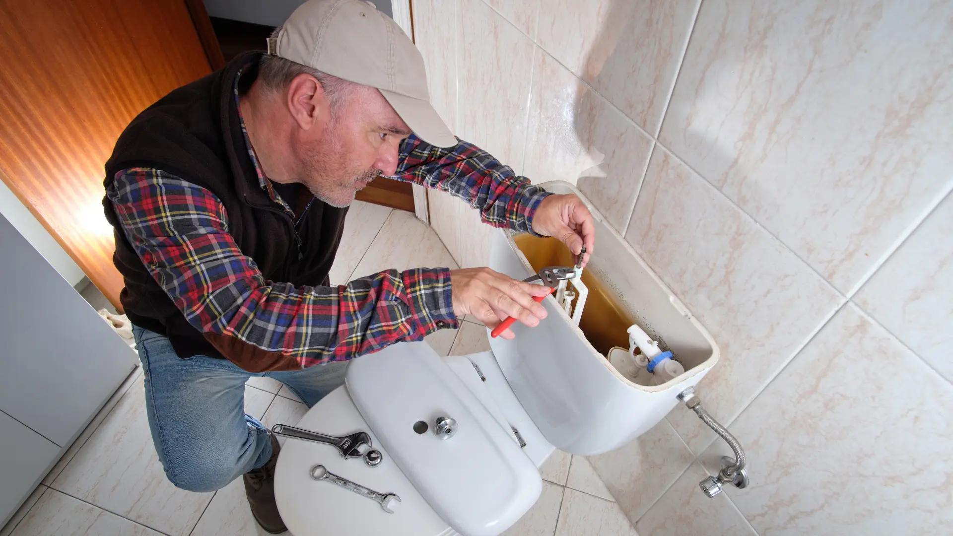 toilet being repaired by plumber technician