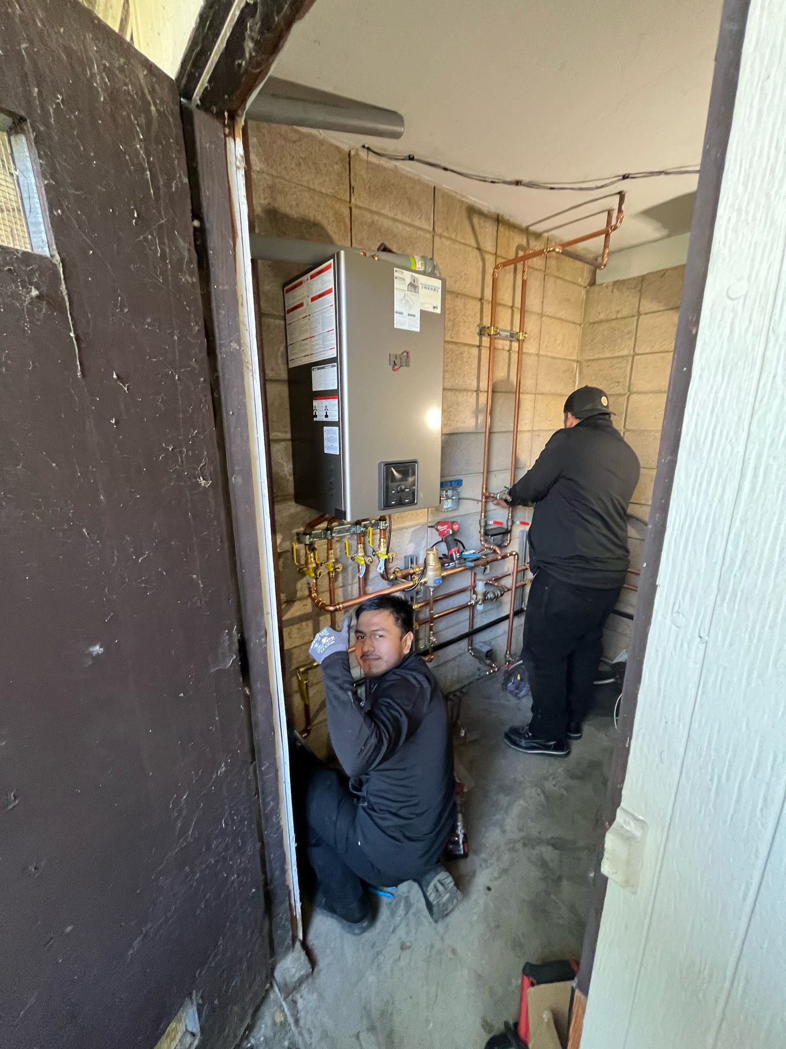 Flow Masters Plumbing HVAC team fixing the heating system.