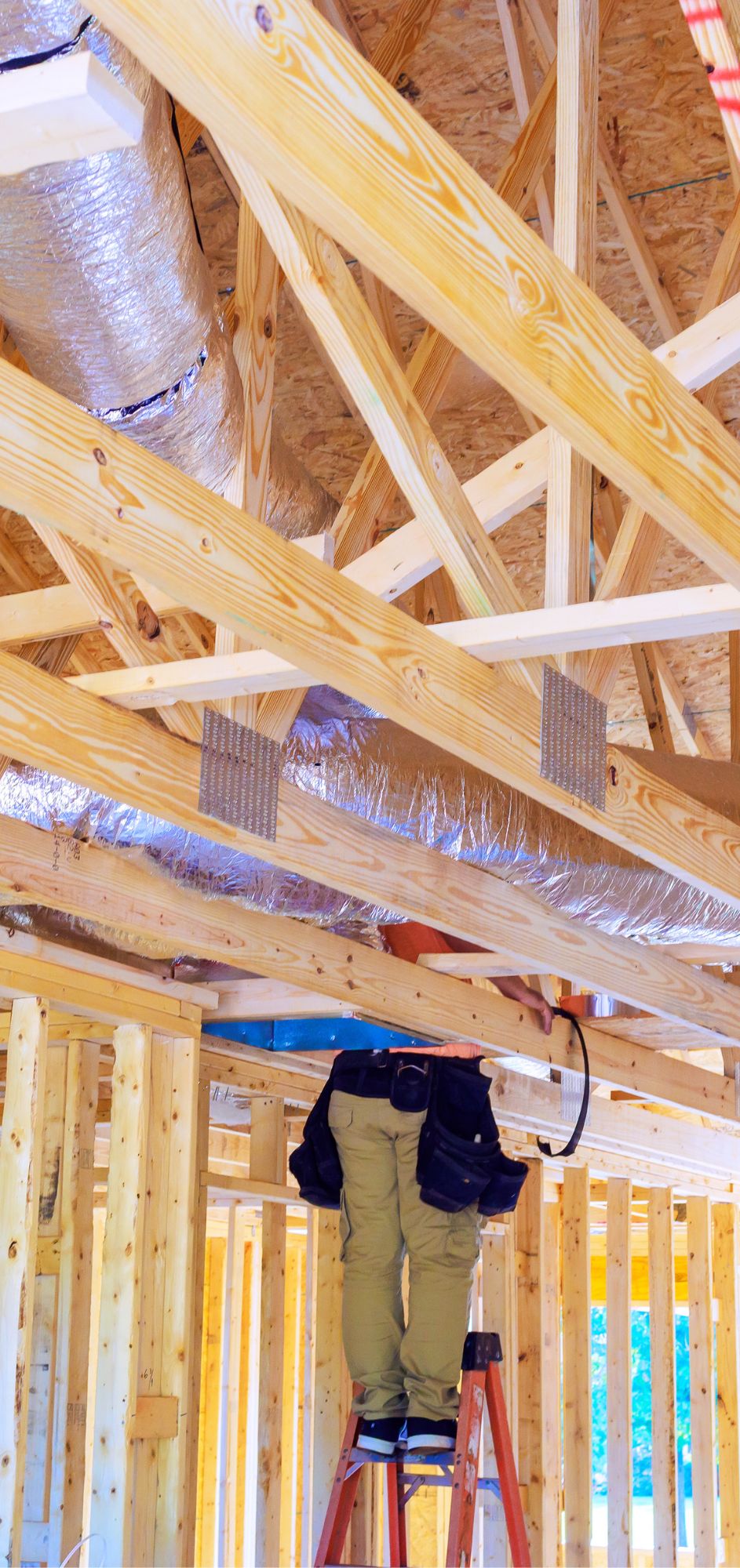 Insulated HVAC ducts in a wooden attic